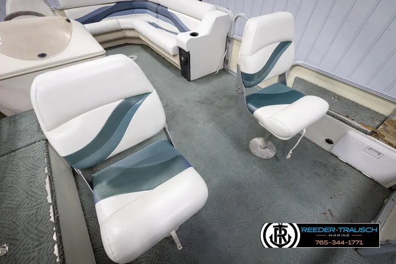 Slide: The Image of 2002 Suncruiser Trinidad 224 boat interior with white and teal seating. - 19
