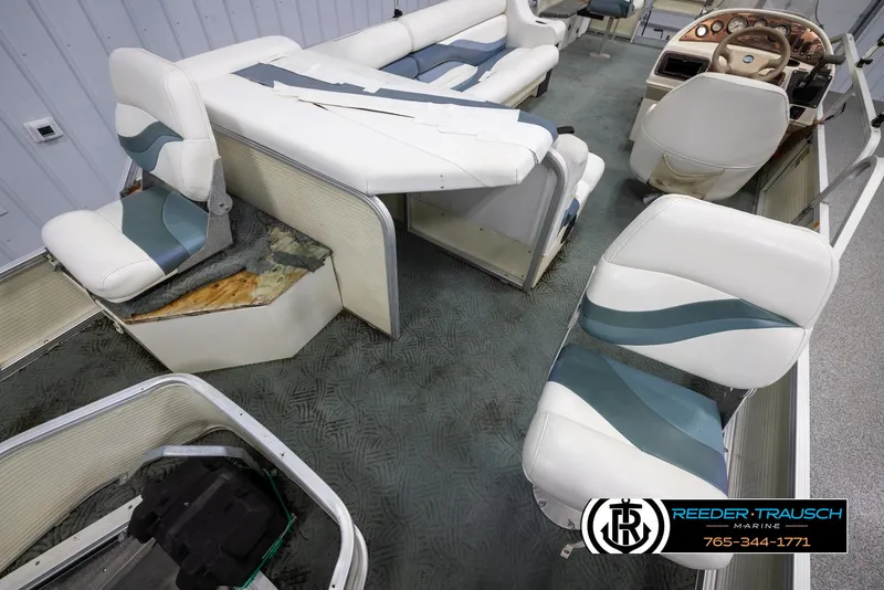 Slide: The Image of 2002 Suncruiser Trinidad 224 boat interior with damaged seating and worn upholstery. - 21