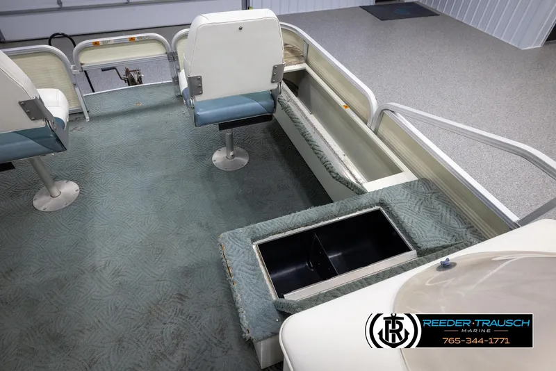 Slide: The Image of Interior of a 2002 Suncruiser Trinidad 224 pontoon boat with seating and storage compartments. - 24