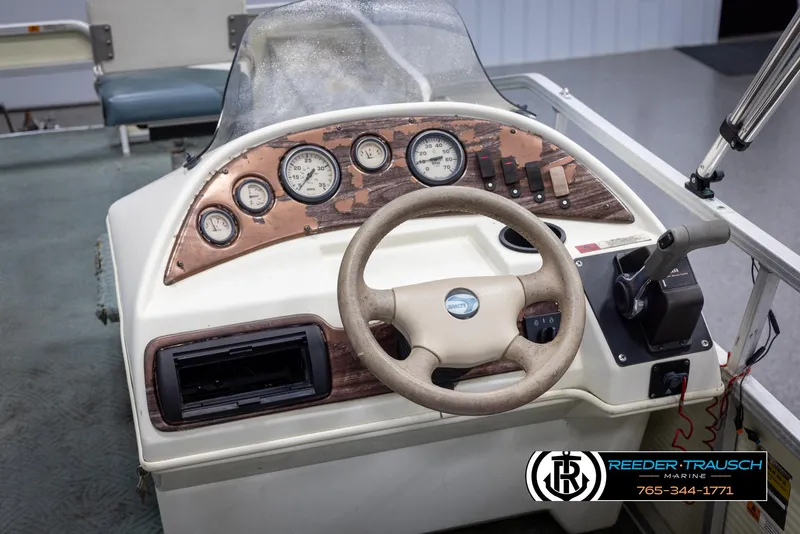 Slide: The Image of 2002 Suncruiser Trinidad 224 boat dashboard with steering wheel and instrument panel. - 29