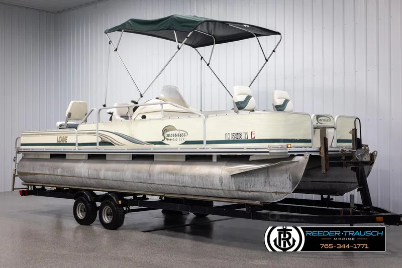 Slide: The Image of 2002 Suncruiser Trinidad 224 pontoon boat on trailer in indoor storage. - 3
