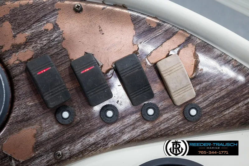 Slide: The Image of Close-up of 2002 Suncruiser Trinidad 224 boat dashboard with worn switches. - 32
