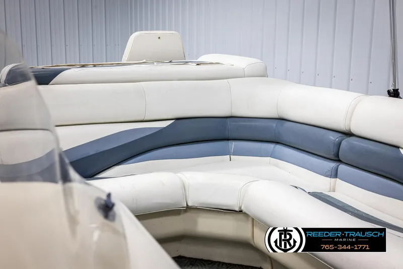 Slide: The Image of 2002 Suncruiser Trinidad 224 boat interior with white and blue seating. - 36