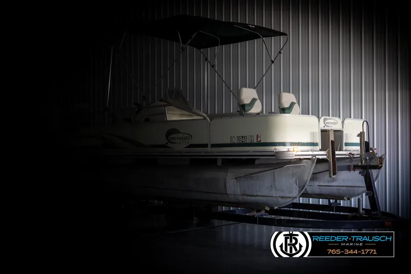 Slide: The Image of 2002 Suncruiser Trinidad 224 pontoon boat in storage, Reeder-Trausch Marine logo visible. - 4