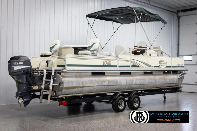Slide: The Image of 2002 Suncruiser Trinidad 224 pontoon boat with Yamaha outboard motor in indoor storage. - 6