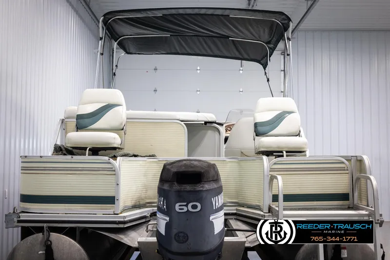 Slide: The Image of 2002 Suncruiser Trinidad 224 pontoon boat with Yamaha 60 HP motor in storage. - 7