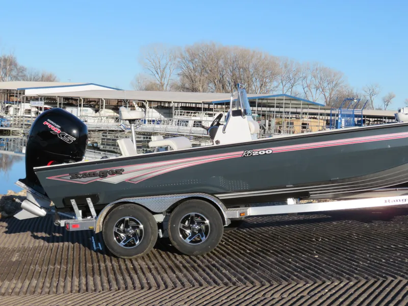 Slide: The Image of 2024 Ranger RB200 boat on trailer at marina with outboard motor. - 1