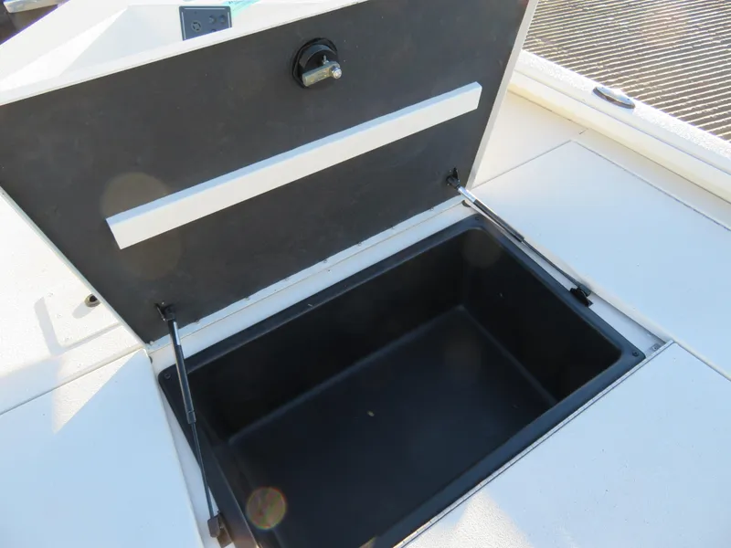 Slide: The Image of Open storage compartment on a 2024 Ranger RB200 boat. - 11