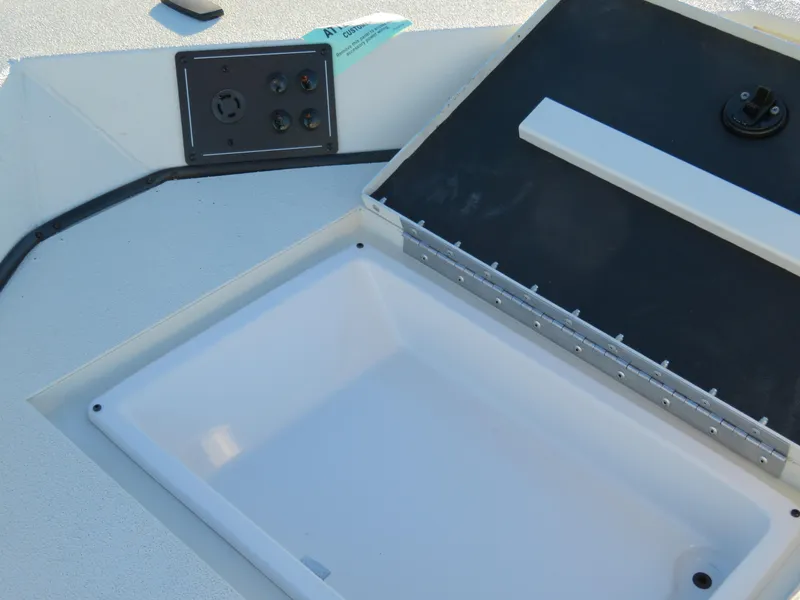 Slide: The Image of 2024 Ranger RB200 boat storage compartment and control panel. - 14