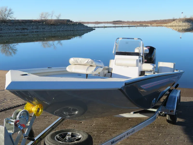 Slide: The Image of 2024 Ranger RB200 boat on trailer by a calm lake. - 2