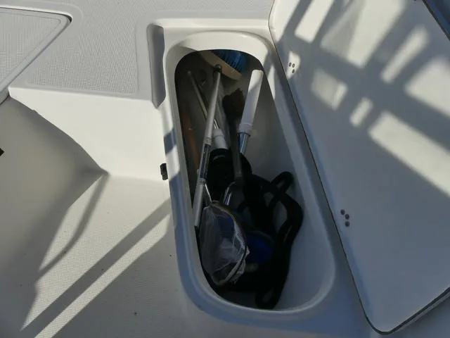 Slide: The Image of Open storage compartment on 2011 Sailfish 218 CC boat with snorkeling gear. - 15