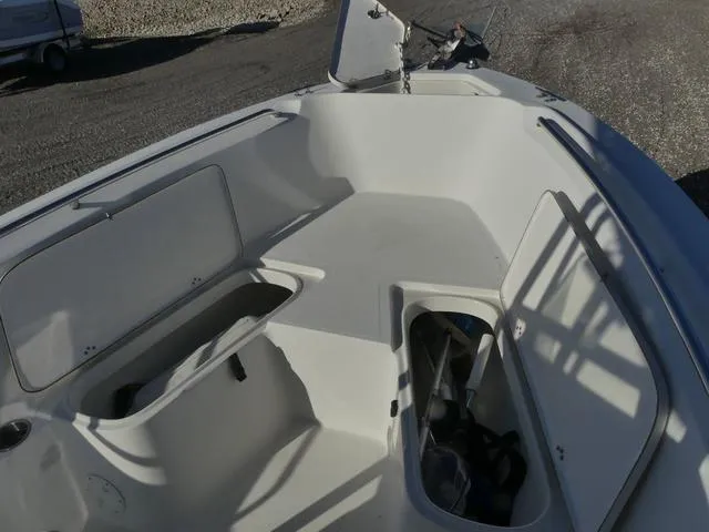 Slide: The Image of 2011 Sailfish 218 CC boat interior with open storage compartments. - 17