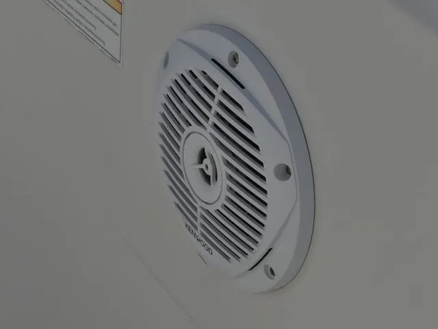 Slide: The Image of White Kenwood speaker on 2011 Sailfish 218 CC boat interior. - 21