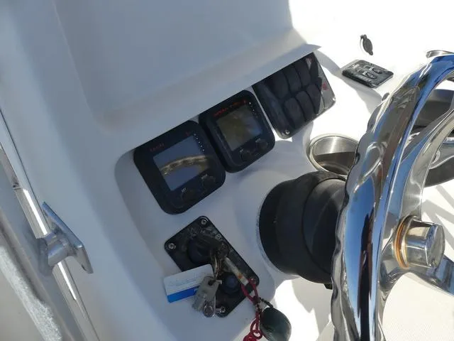 Slide: The Image of 2011 Sailfish 218 CC boat dashboard with steering wheel and control panel. - 27