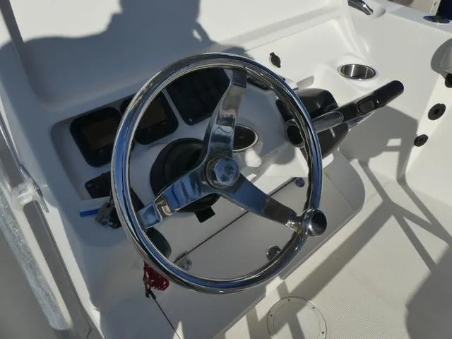 Slide: The Image of Steering wheel of 2011 Sailfish 218 CC boat, featuring a sleek control panel. - 28
