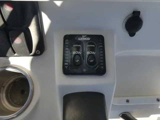 Slide: The Image of Lenco trim tab controls on 2011 Sailfish 218 CC boat dashboard. - 29