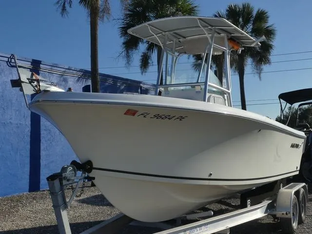 Slide: The Image of 2011 Sailfish 218 CC boat on trailer under a partly cloudy sky. - 3