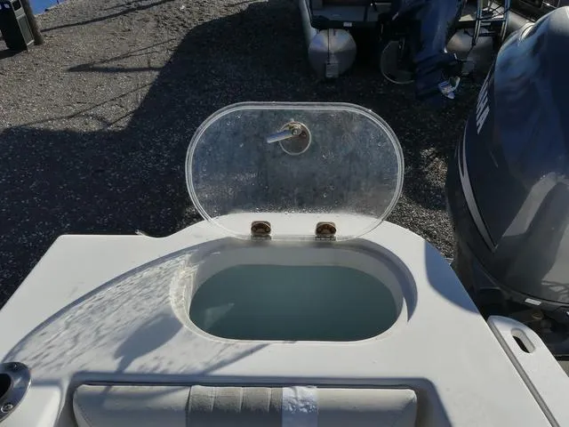 Slide: The Image of Open livewell on 2011 Sailfish 218 CC boat, showing water inside. - 34