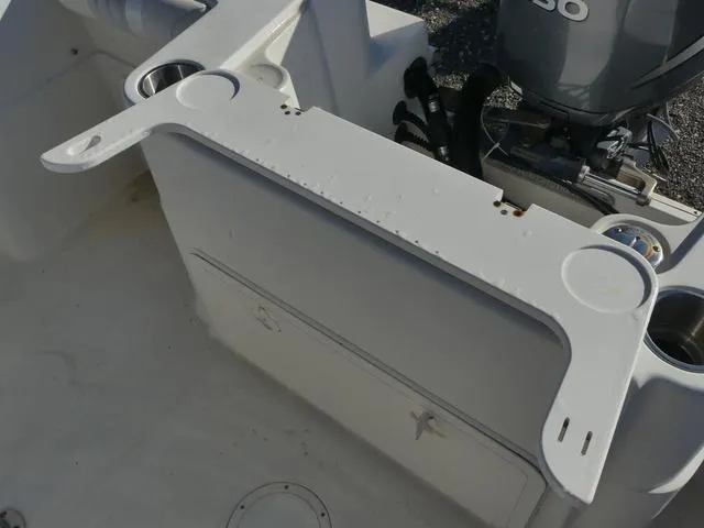 Slide: The Image of 2011 Sailfish 218 CC boat interior with storage compartment and motor. - 36