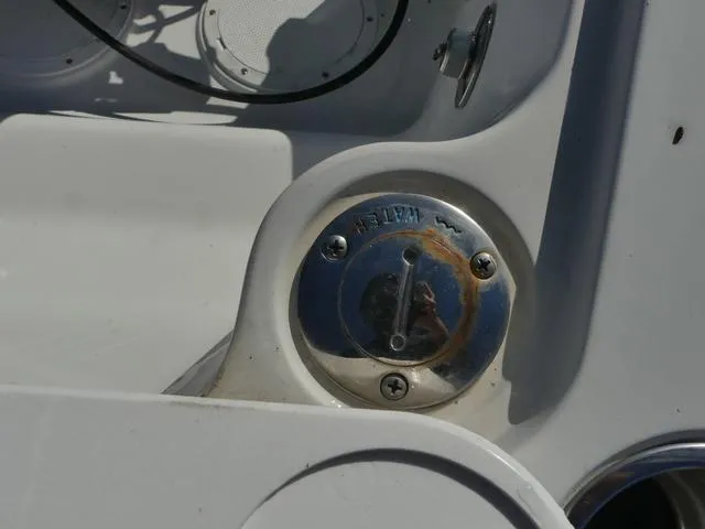 Slide: The Image of Close-up of a 2011 Sailfish 218 CC boat's metal fuel cap with slight rust. - 37