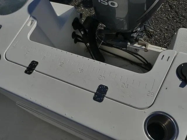 Slide: The Image of Close-up of 2011 Sailfish 218 CC boat's measuring board and motor. - 38