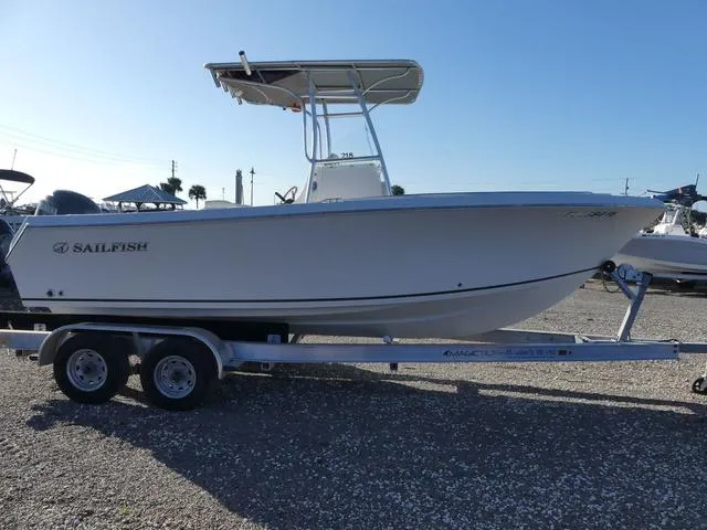 Slide: The Image of 2011 Sailfish 218 CC boat on trailer, side view, clear sky background. - 7