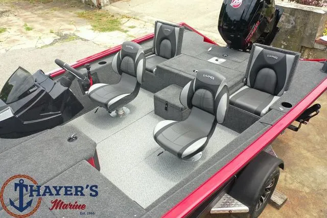 Slide: The Image of 2024 Lund 1875 Renegade SS fishing boat interior with seating and console, Thayer's Marine logo. - 16