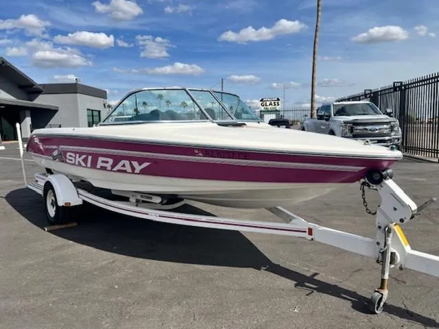 Slide: The Image of 1992 Sea Ray Ski Ray boat on trailer under a clear sky. - 4