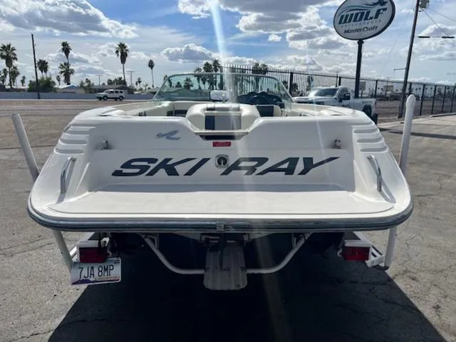 Slide: The Image of 1992 Sea Ray Ski Ray boat rear view at dealership under cloudy sky. - 7