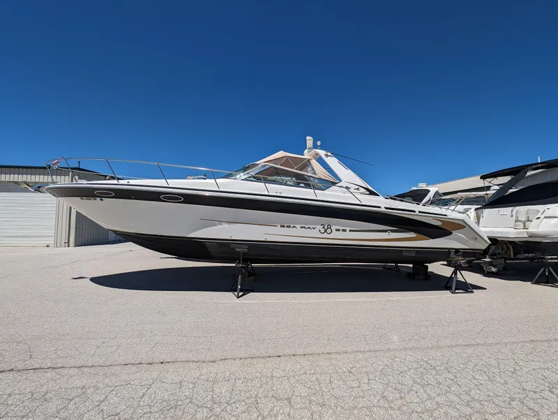 The Image of 1995 Sea Ray 380 Sun Sport boat on stands in a marina. - 0