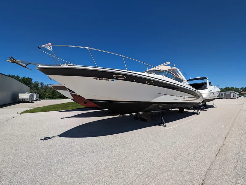 Slide: The Image of 1995 Sea Ray 380 Sun Sport boat on dry dock under clear blue sky. - 19