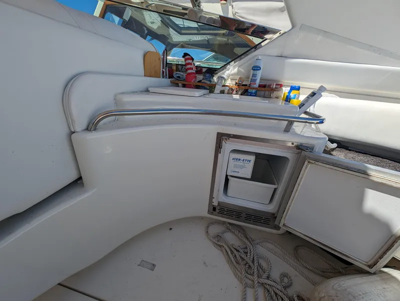 Slide: The Image of Interior of 1995 Sea Ray 380 Sun Sport with mini fridge and storage. - 6