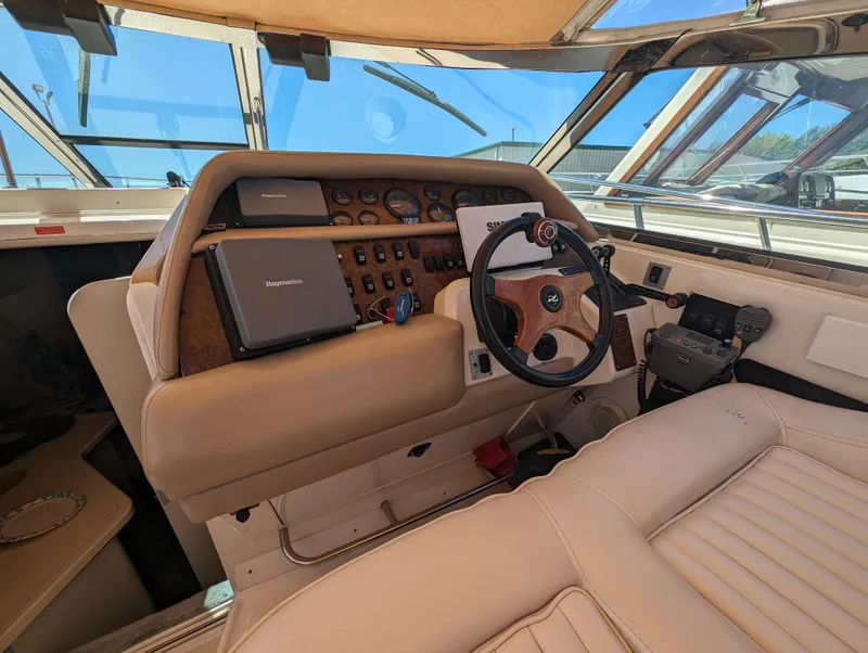 Slide: The Image of 1995 Sea Ray 380 Sun Sport helm with steering wheel and navigation equipment. - 7