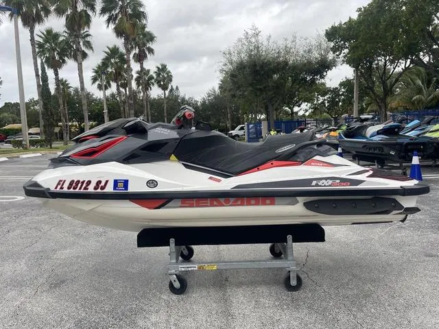 Slide: The Image of 2016 Sea-Doo Waverunner RXP parked on a trailer in a lot. - 1