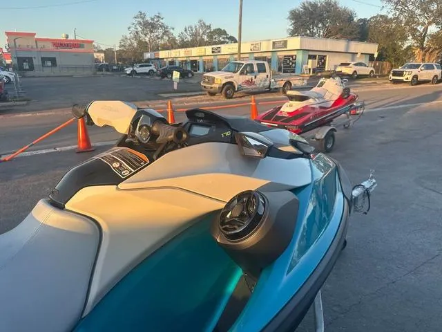 Slide: The Image of 2024 Sea-Doo Waverunner GTI parked outdoors near vehicles and traffic cones. - 6