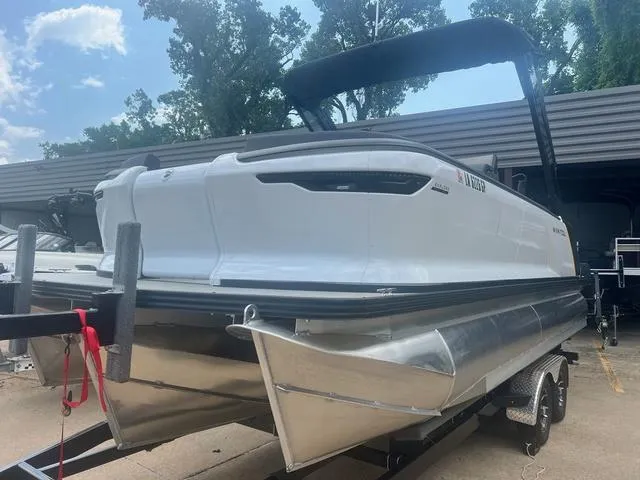 Slide: The Image of 2023 Manitou Explore 22 Bench pontoon boat on trailer, side view. - 3