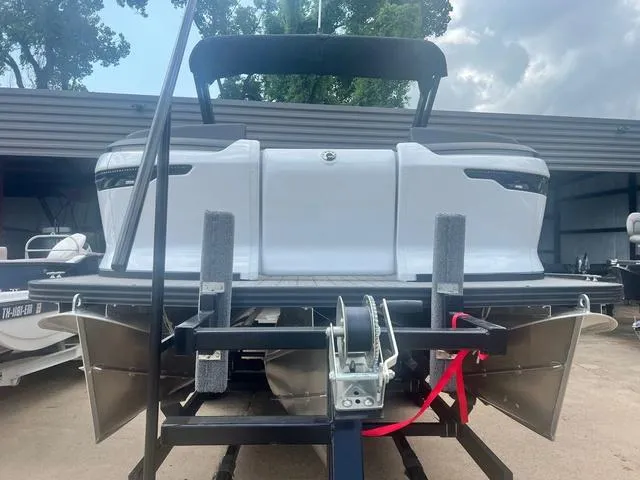 Slide: The Image of 2023 Manitou Explore 22 Bench pontoon boat on trailer. - 4