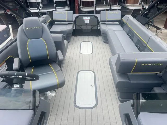 Slide: The Image of 2023 Manitou Explore 22 Bench pontoon boat interior with gray seating and yellow accents. - 6