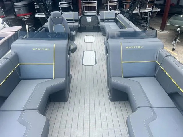 Slide: The Image of 2023 Manitou Explore 22 Bench pontoon boat with spacious seating and modern design. - 7