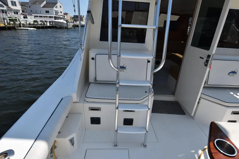 Slide: The Image of 1994 Cabo 35 Flybridge Sportfisher boat interior with ladder and seating. - 11