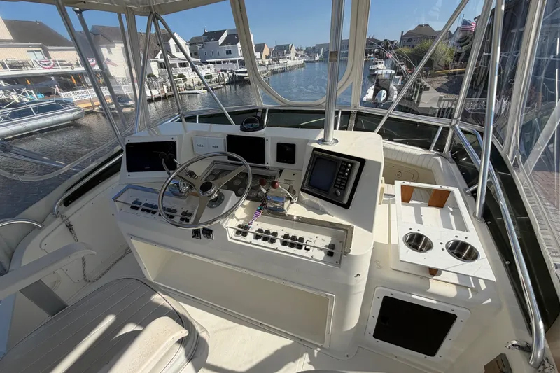 Slide: The Image of Cockpit of 1994 Cabo 35 Flybridge boat with steering wheel and navigation equipment. - 73