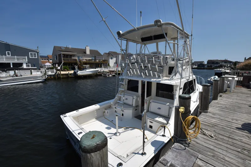 Slide: The Image of 1994 Cabo 35 Flybridge Sportfisher docked at a marina. - 18