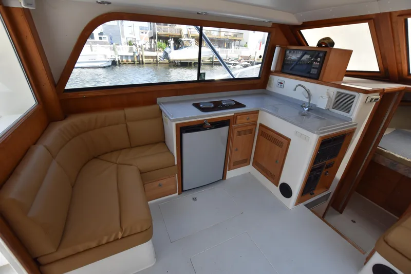 Slide: The Image of Interior of a 1994 Cabo 35 Flybridge Sportfisher with kitchenette and seating area. - 19