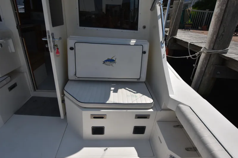 Slide: The Image of 1994 Cabo 35 Flybridge Sportfisher boat interior with cushioned seating and storage. - 26