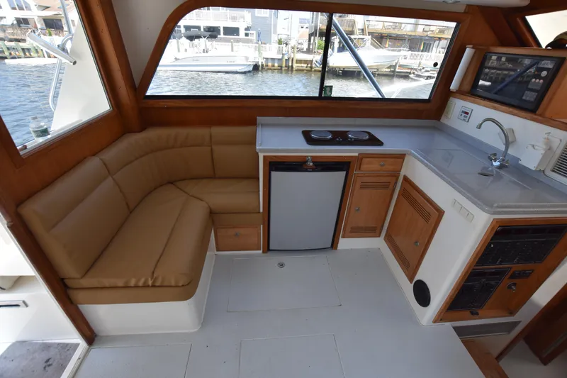 Slide: The Image of Interior of 1994 Cabo 35 Flybridge Sportfisher with kitchenette and seating area. - 34