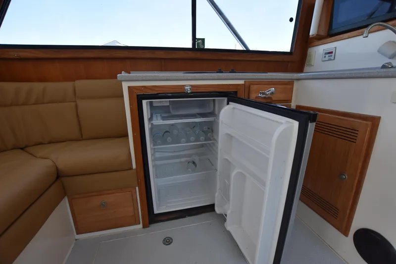 Slide: The Image of Open refrigerator in the cabin of a 1994 Cabo 35 Flybridge Sportfisher boat. - 36