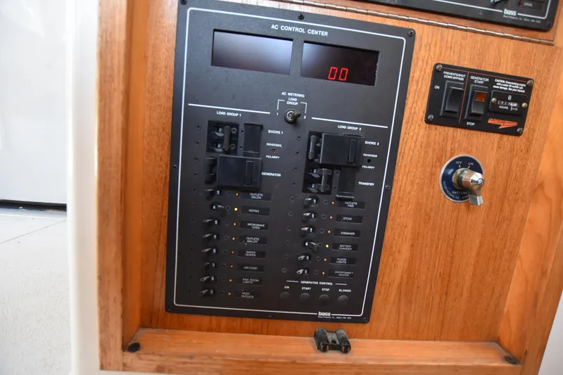 Slide: The Image of AC control panel of a 1994 Cabo 35 Flybridge Sportfisher boat. - 40