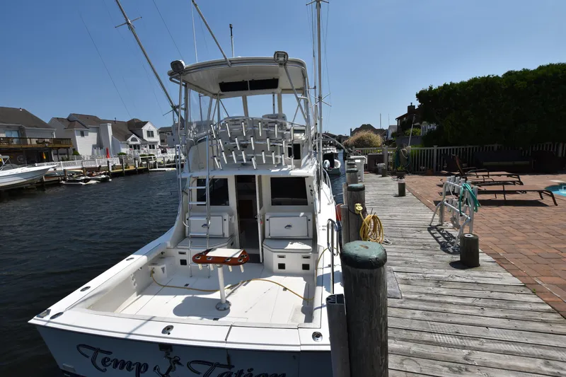 Slide: The Image of 1994 Cabo 35 Flybridge Sportfisher docked at a marina on a sunny day. - 5