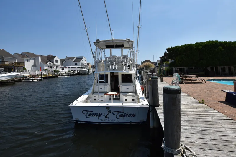 Slide: The Image of 1994 Cabo 35 Flybridge Sportfisher docked at a marina. - 6
