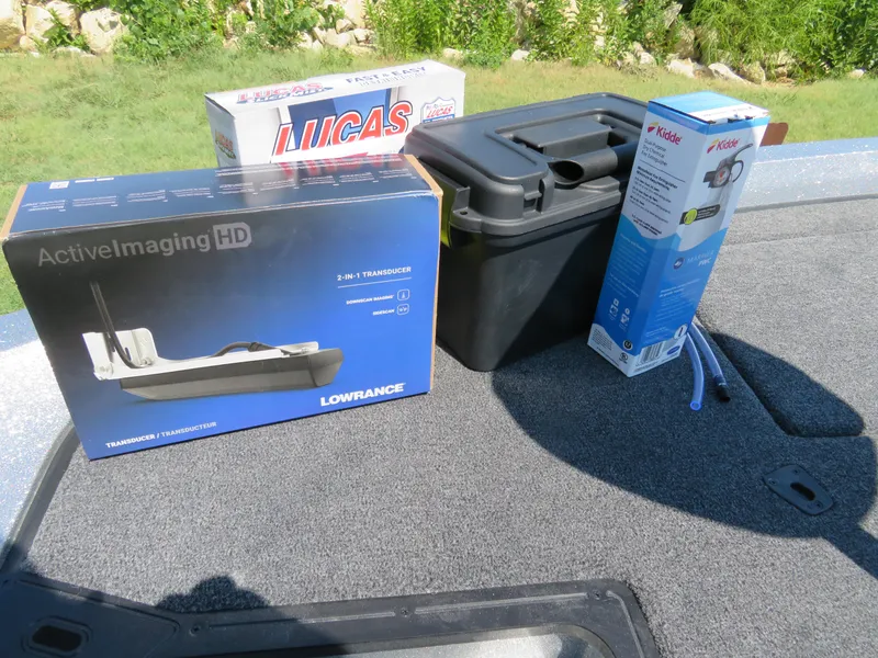 Slide: The Image of Boxes of Lowrance Active Imaging HD, Lucas Oil, and Kidde products on a 2024 Ranger Z519 boat. - 9